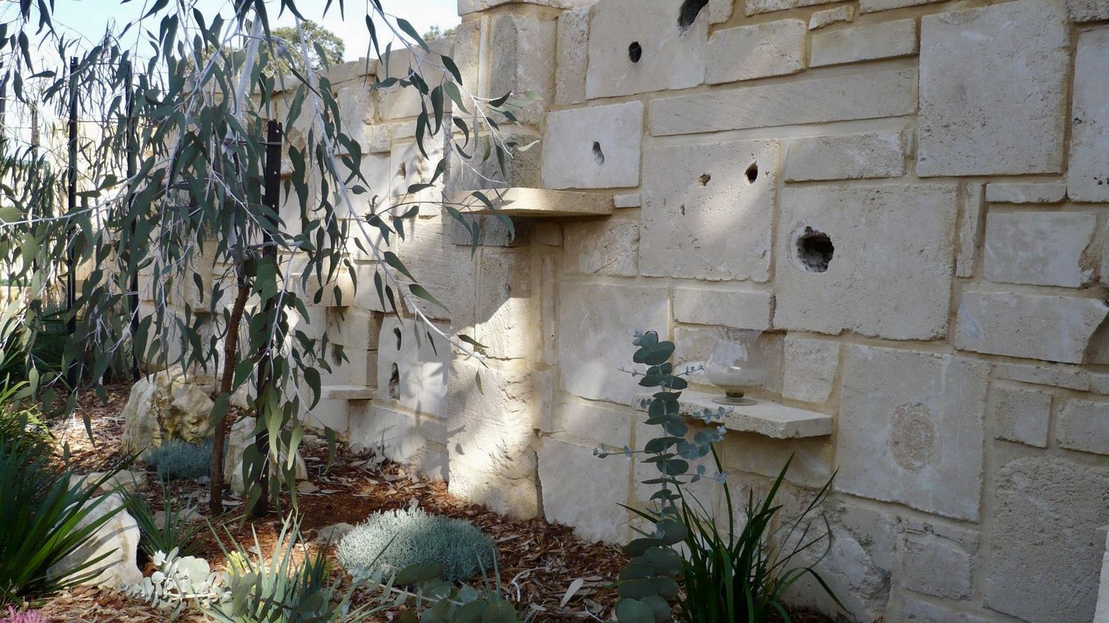 Limestone feature wall with water spouts