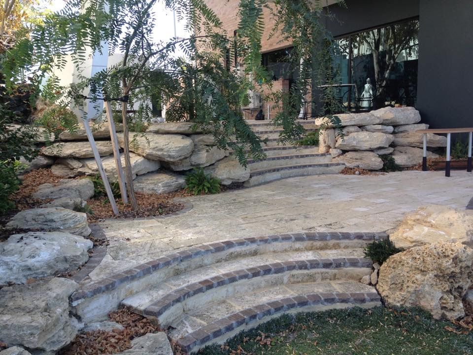 Curved limestone steps with brick nosing